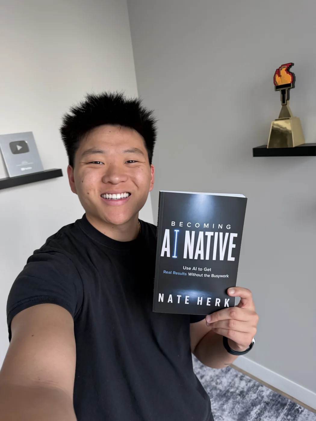 Nate Herk holding up a copy of Becoming AI Native.