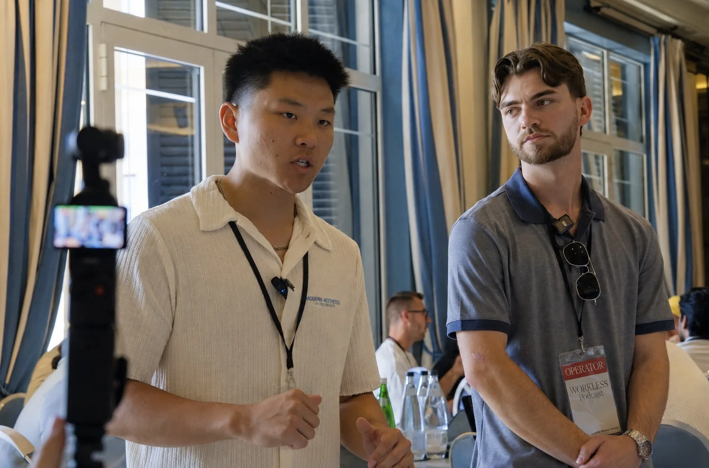 Nate Herk teaching a room at Workless AI, a camera recording in the foreground.